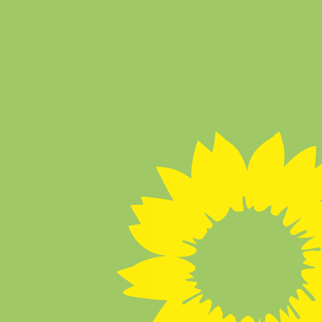 A green background with a yellow sunflower in the foreground.